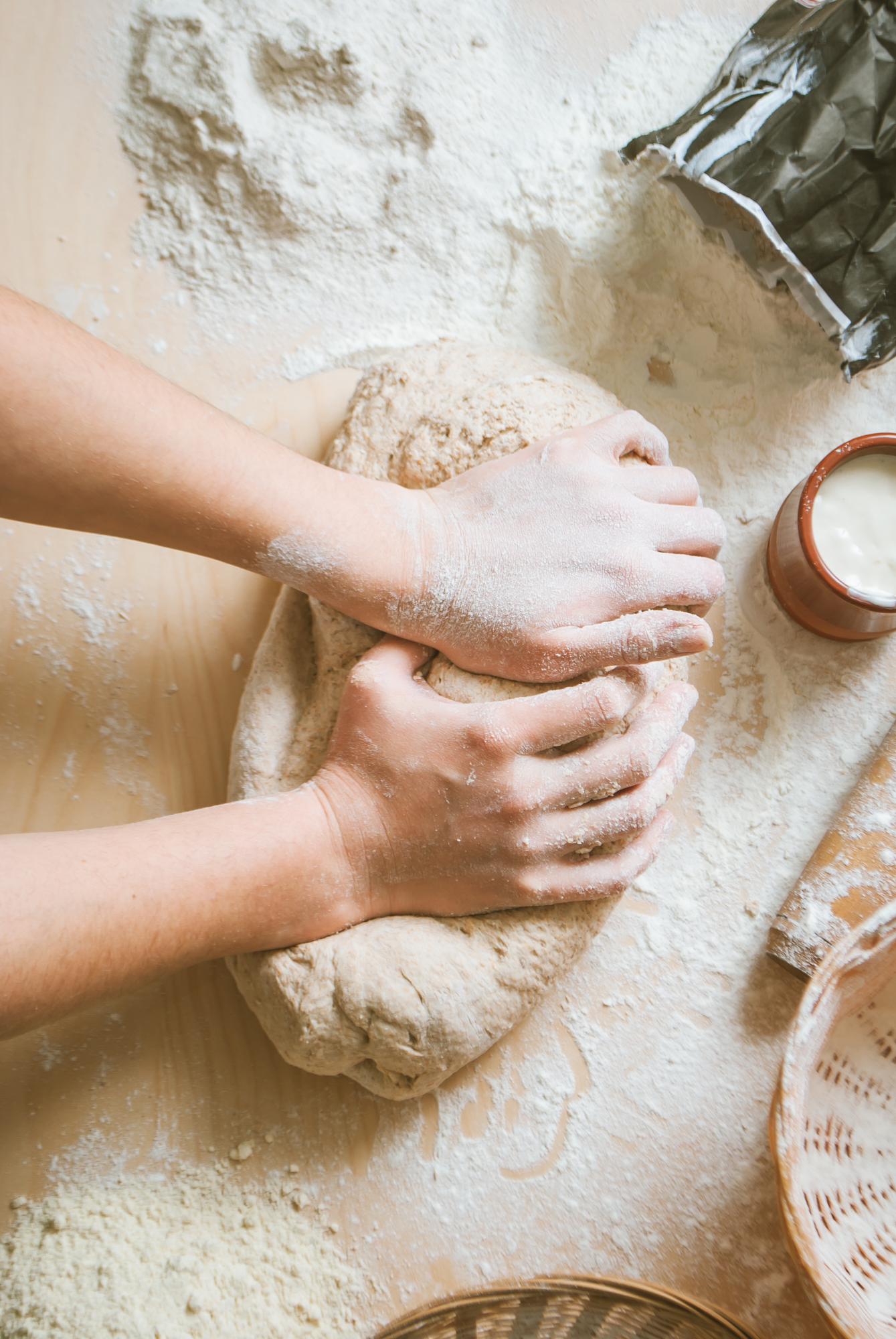 Close-up hands kneading dough