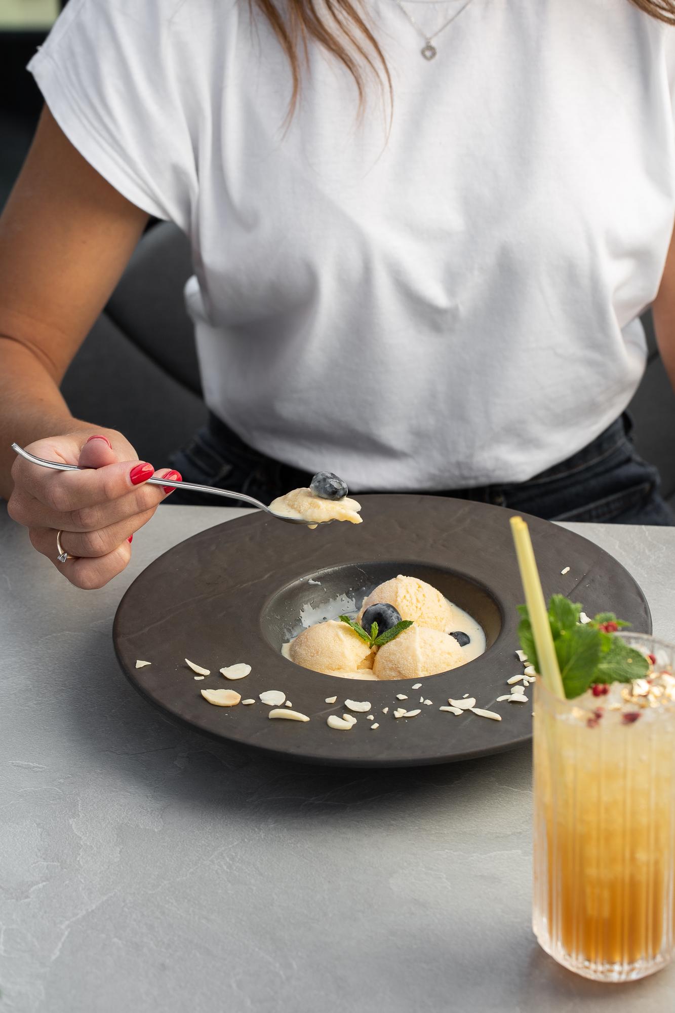 Chef demonstrating a plated dish in a calm studio